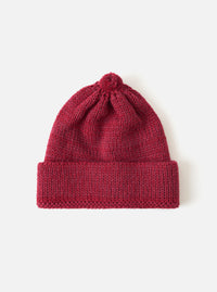 Close-up of a Red Alpaca/British Wool Bobble Hat on a white background. The knitted hat has a bobble on top and a folded brim.