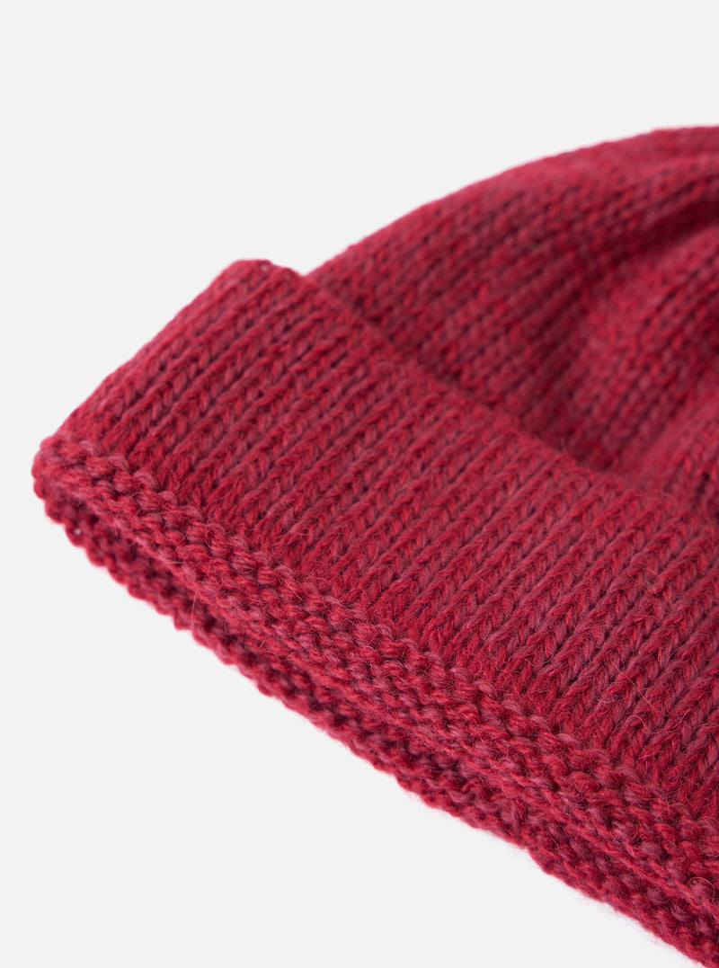 Close-up of a Red Alpaca/British Wool Bobble Hat on a white background. The knit is clearly visible.