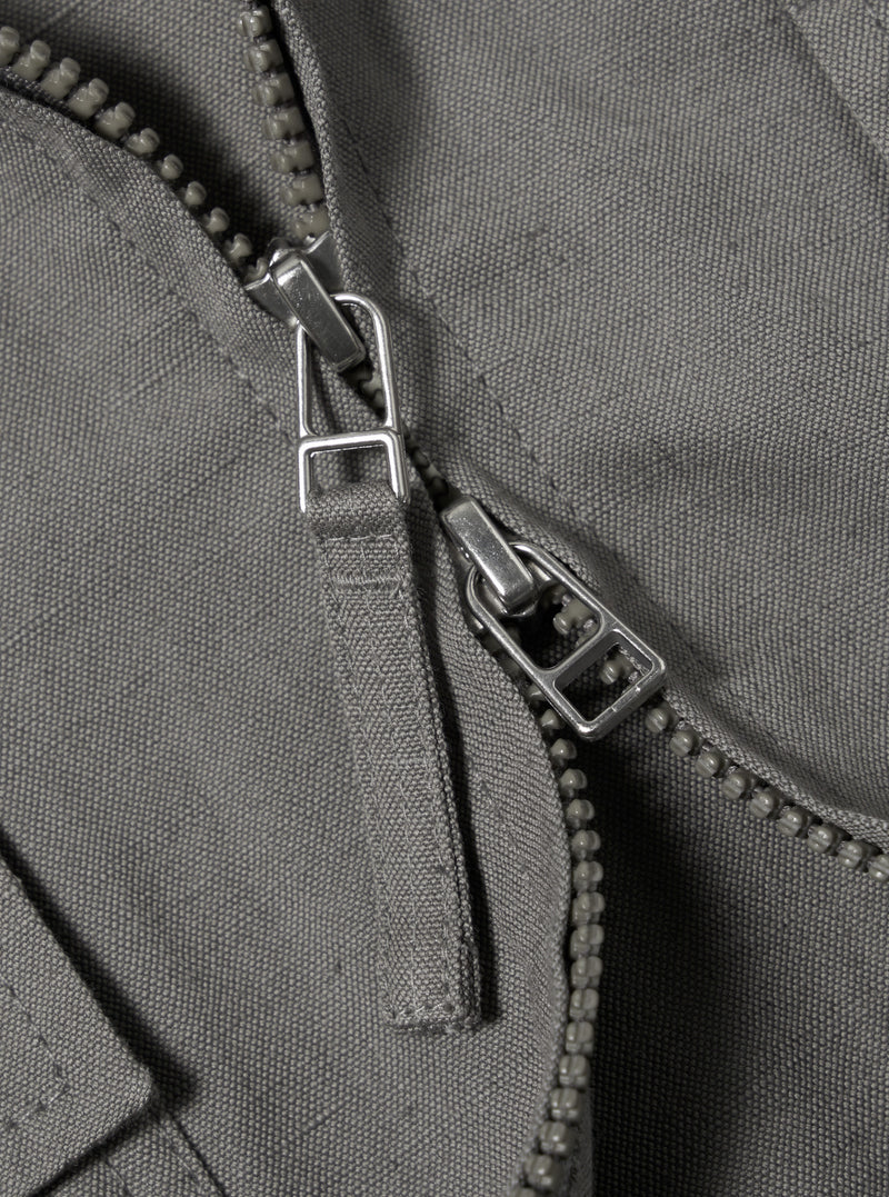 The Mid Grey Linen Slub Weave E130 Jacket is displayed from the back, laid flat against a solid white background. The image highlights the horizontal back yoke, the straight hem, and the textured slub weave of the grey linen fabric.