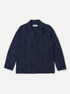 The Navy Linen Slub Weave Manor Jacket is shown as a flat lay against a plain white background. The jacket features a double-breasted front with a four-button closure, two large lower patch pockets, and a single welt pocket at the chest. The navy fabric has a visible textured slub weave.
