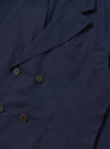 The Navy Linen Slub Weave Manor Jacket is shown from the back as a flat lay against a plain white background. The image highlights the clean construction of the jacket's rear panel, featuring a central vertical seam and a straight hem. The navy blue linen fabric has a distinct slubby texture with visible natural variations in the weave.
