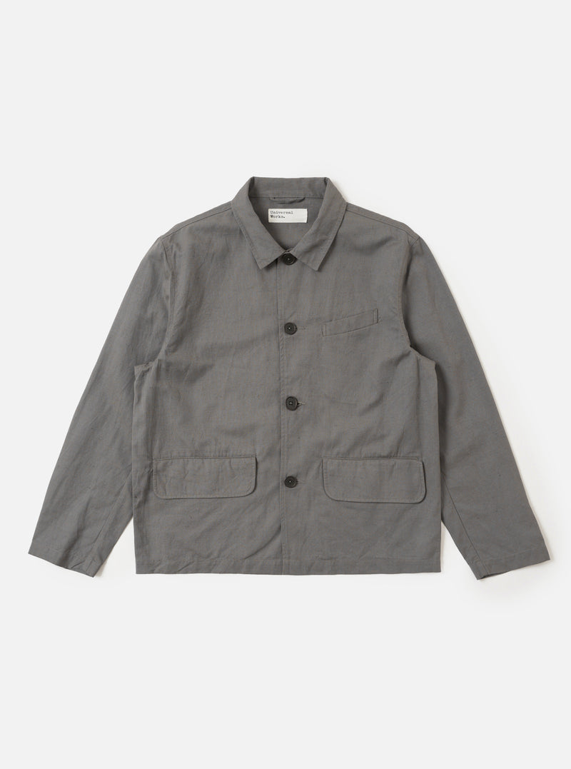 The Mid Grey Linen Slub Weave Franck Jacket is shown as a flat lay against a white background. The jacket features a four-button front closure, a structured collar with notch lapels, and three front patch pockets including one chest pocket and two larger pockets at the waist. The mid-grey fabric has a visible slubbed texture and a clean, straight hem.