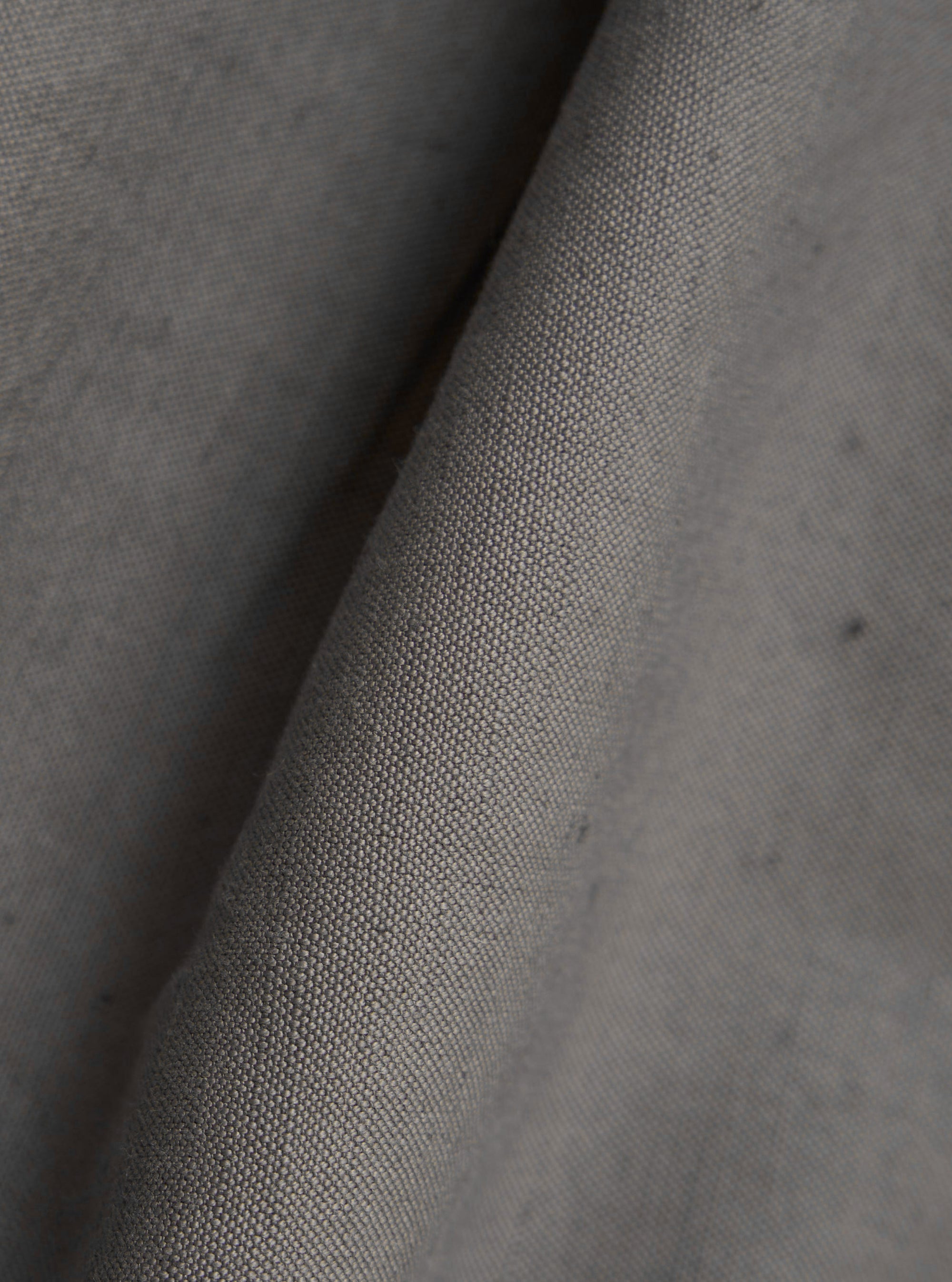 A close-up fabric swatch of the Mid Grey Linen Slub Weave Two Button Jacket displays the textured, grainy finish and distinct horizontal slubbing of the mid-grey linen and cotton blend fabric.