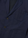 The Navy Linen Slub Weave Two Button Jacket is shown from the back as a flat lay against a plain white background. The image highlights the jacket's structured shoulders, a single central vent at the hem, and the textured, irregular slubbed appearance of the navy blue linen-cotton blend fabric.