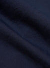 A close-up fabric swatch of the Navy Linen Slub Weave Two Button Jacket highlights the deep navy blue color and the irregular, textured surface of the linen-cotton blend. The slubby yarns and distinct weave pattern are clearly visible, filling the frame.