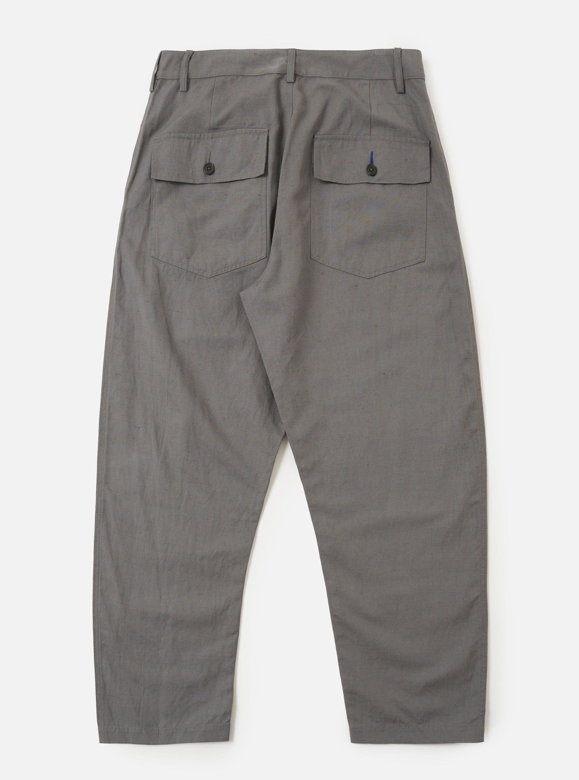 The Mid Grey Linen Slub Weave Dizzy Trouser is shown from a rear angle as a flat lay against a plain white background. The image highlights the two rear pockets, including one with a buttoned flap, and the elasticated waistband. The mid grey fabric features a visible slub texture.