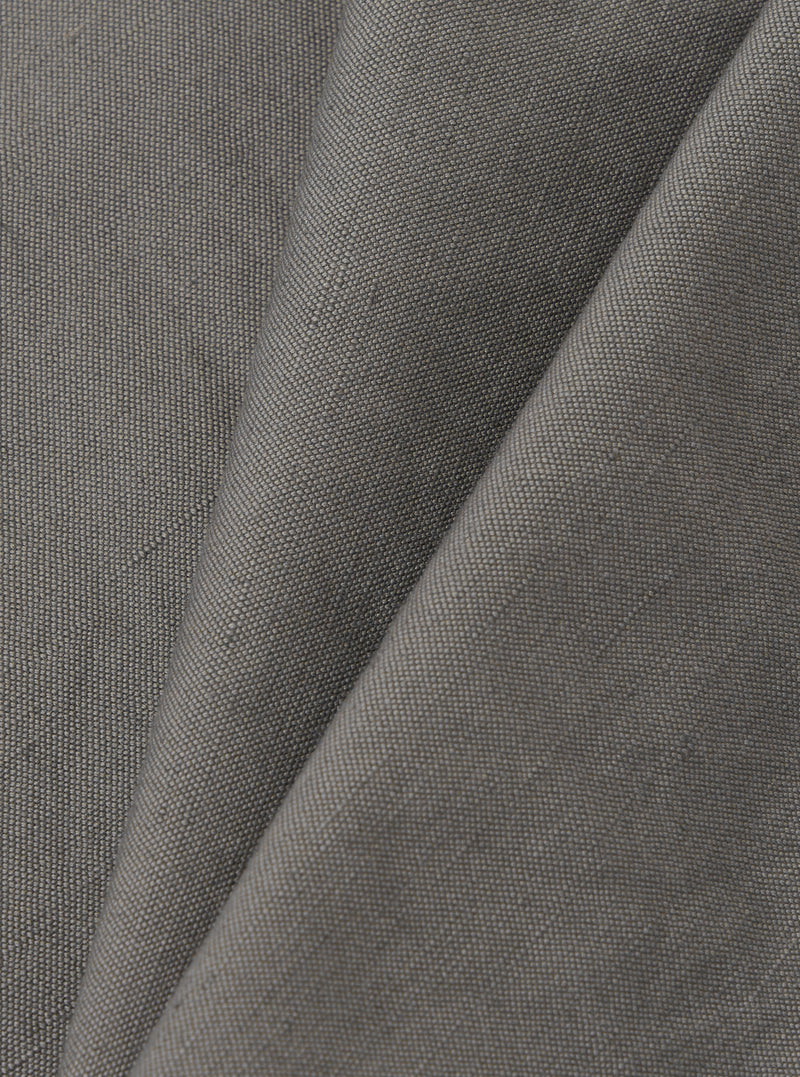 A close-up fabric swatch of the Mid Grey Linen Slub Weave Dizzy Trouser is shown, highlighting the mid-grey color and the distinct, irregular texture of the slub weave fabric.