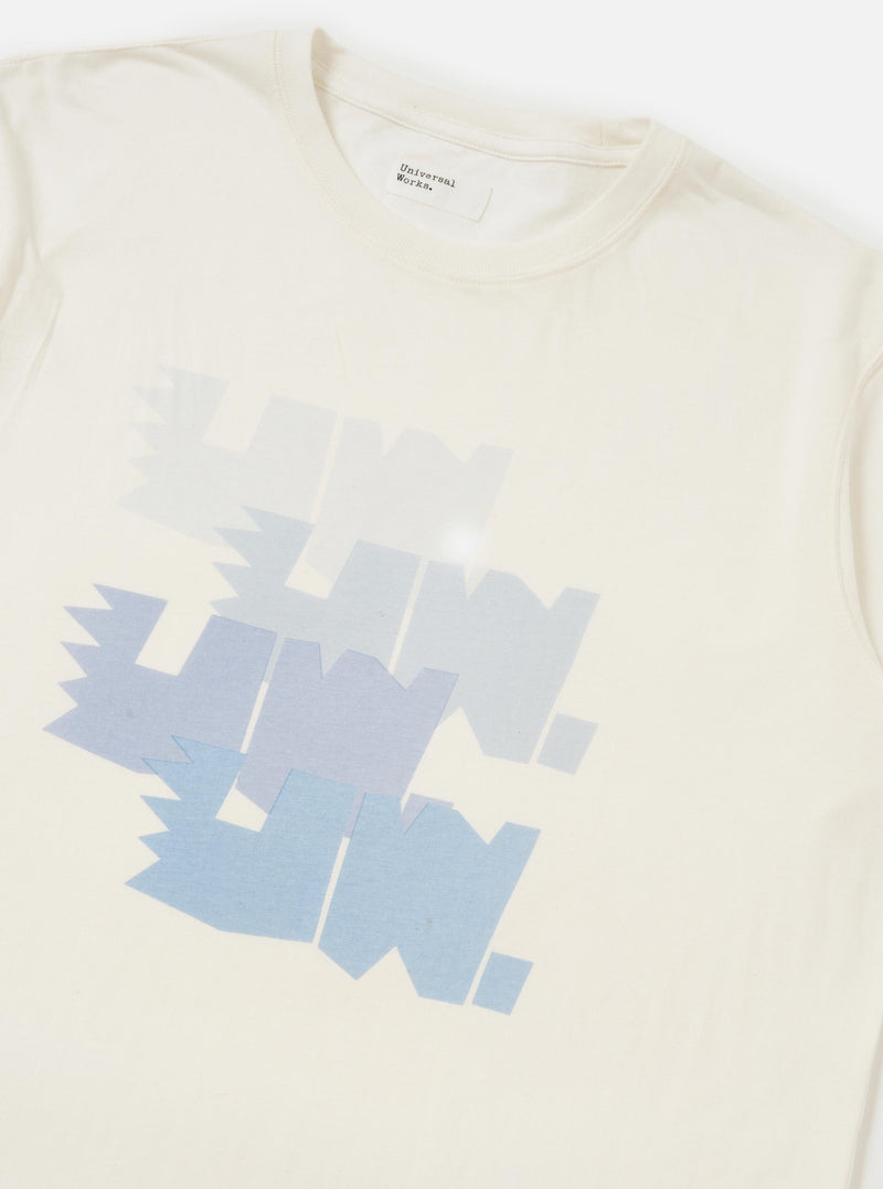 The Ecru Single Jersey Multi UW Print Multi UW Print Tee is displayed from a rear perspective, laid flat against a solid white background. The image highlights the short-sleeve construction, a simple crew neck, and a small woven branded label positioned near the straight hem.