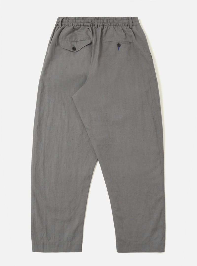 The Mid Grey Linen Slub Weave Oxford Pant is shown from the back, laid flat against a plain white background. The trousers feature an elasticated waistband and two large rear patch pockets. The mid-grey fabric has a visible slubby texture.