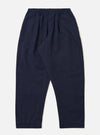 The Navy Linen Slub Weave Oxford Pant is shown as a flat lay against a plain white background. The trousers feature a loose, straight-leg fit, an elasticated waistband with an external drawstring, and two side pockets. The fabric is a deep navy blue with a visible irregular slubbed texture.