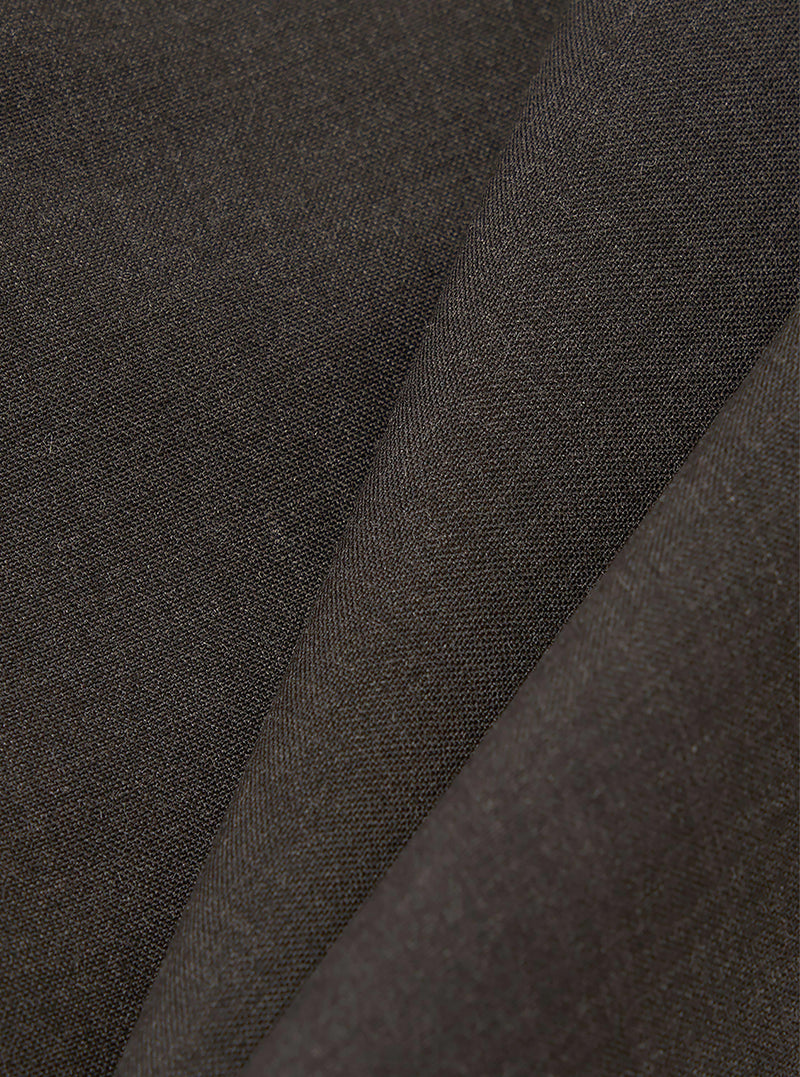 A close-up fabric swatch of the Brown Marl Tropical Suiting Dutch Pant shows a detailed view of the brown marl material. The image highlights the fine, textured weave of the tropical suiting fabric, which consists of a blend of polyester and wool.