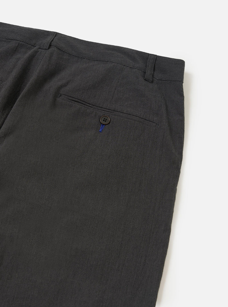 A close-up view of the back of a pair of Charcoal Seattle Cotton Military Chinos, focusing on the waistband and a single rear buttoned flap pocket. The charcoal grey cotton fabric is shown against a plain white background.