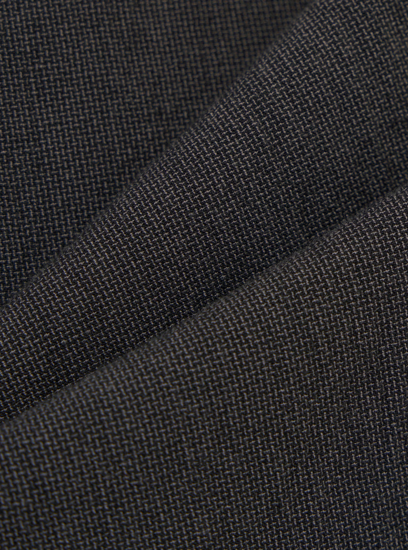 A detailed, close-up fabric swatch of the charcoal grey Seattle cotton material used for the Military Chino. The image highlights the fine weave and textured surface of the fabric.