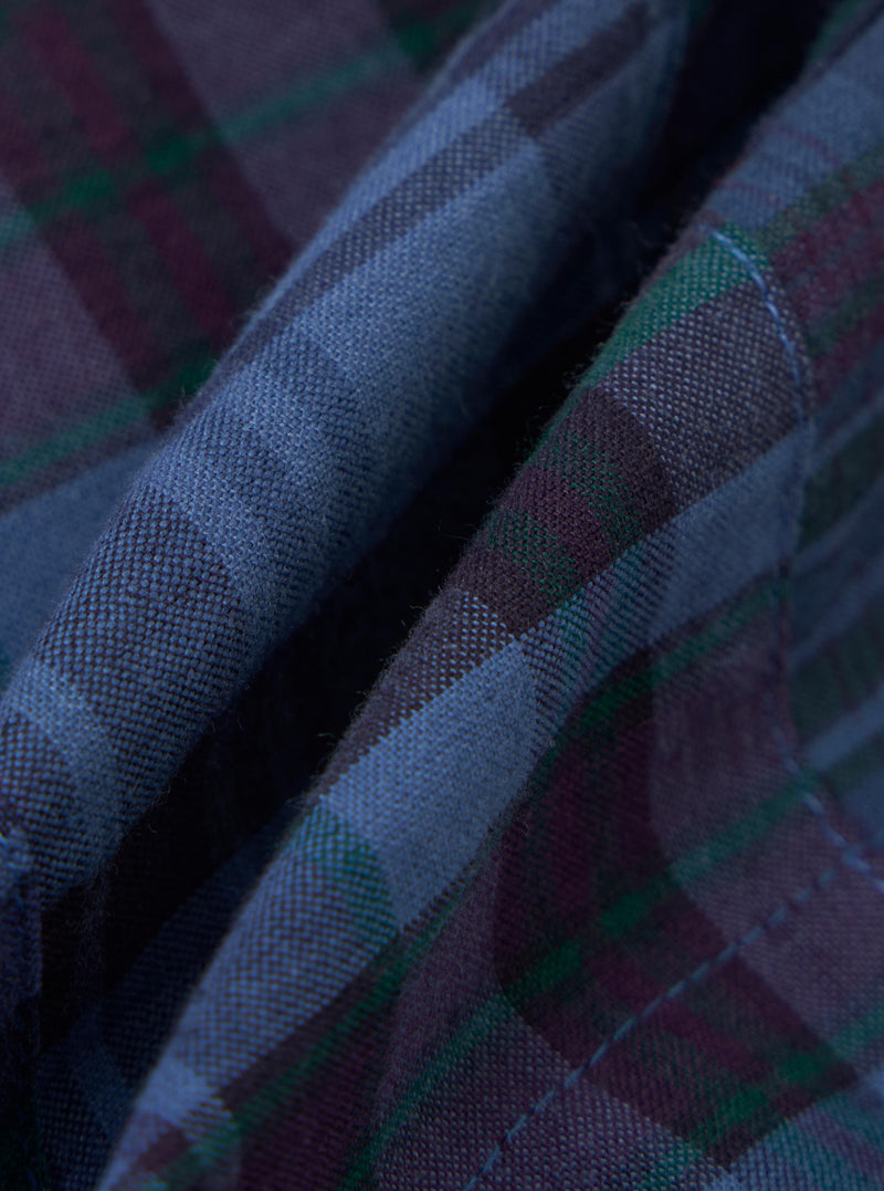 A close-up fabric swatch of the Navy Madras Patchwork Vacation Short shows a textured patchwork design with various blue and navy checkered patterns.