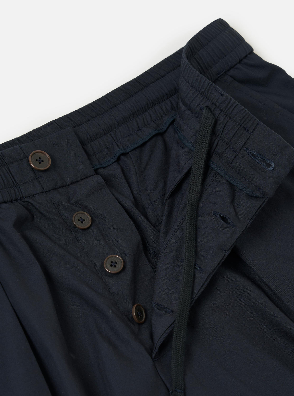The Navy Broadcloth Oxford Pant is displayed flat against a plain white background. The trousers feature a wide-leg silhouette, a pleated front, and an adjustable drawstring at the waistband.