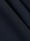 A close-up fabric swatch of the Navy Broadcloth Oxford Pant shows a detailed view of the navy blue material. The image highlights the smooth, tightly woven texture of the broadcloth fabric against a neutral background.