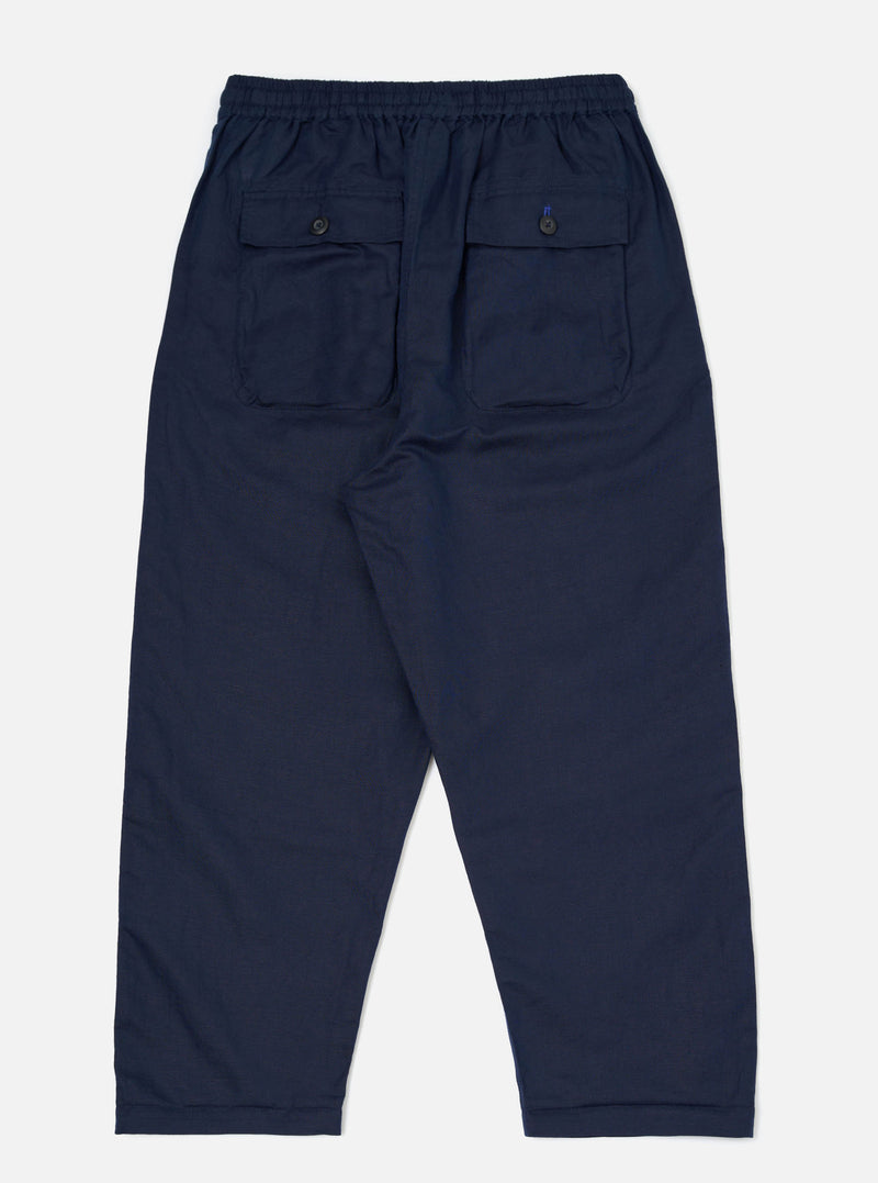 A pair of Navy Linen Cotton Shirting Parachute Pants is shown from the back, laid flat against a plain white background. The navy blue trousers feature a relaxed, straight-leg fit, a drawstring waistband, and two rear patch pockets.