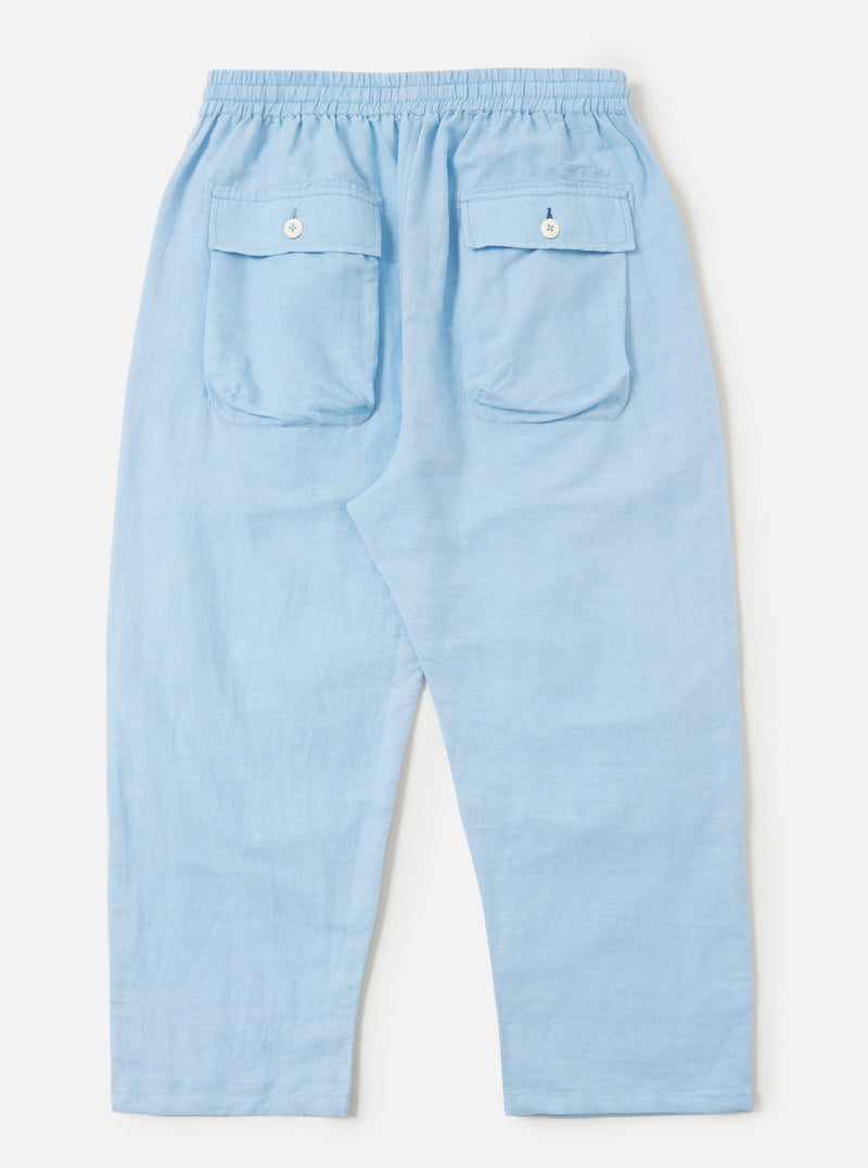 A pair of Pale Blue Linen Cotton Shirting Parachute Pants is shown from the back, laid flat against a solid white background. The trousers feature a relaxed, straight-leg silhouette and a visible drawstring at the waistband.