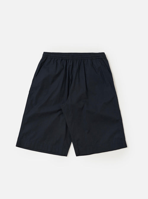 A pair of Navy Broadcloth Vacation Shorts is shown laid flat against a plain white background. The shorts feature a deep navy blue cotton fabric, an elasticated waistband with a drawstring, and a relaxed, straight-leg silhouette.
