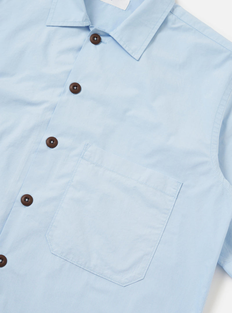 The Sky Blue Paper Touch Cotton S/S Fatigue Shirt is shown from the back, laid flat against a plain white background. The image highlights the short sleeves, a straight hem, and a classic pointed collar.