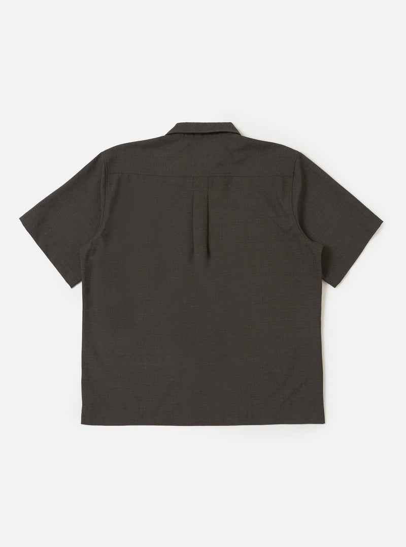 The back of the Brown Marl Tropical Suiting Ewan Shirt is displayed flat against a plain white background. The image highlights the back yoke and a central box pleat designed for a relaxed silhouette. The short sleeves and straight hem are visible, showcasing the textured brown marl fabric.