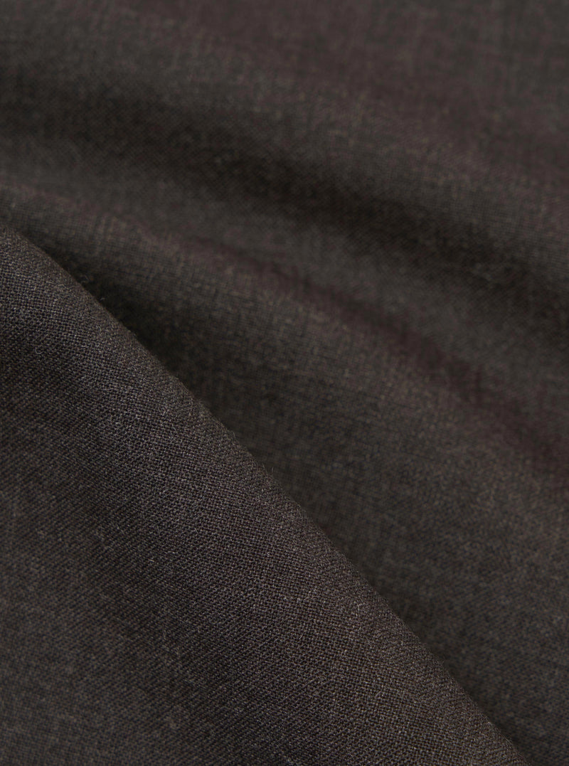 A detailed, close-up fabric swatch of the brown marl tropical suiting material used for the Ewan Shirt. The image highlights the fine weave and textured surface of the mottled brown fabric.