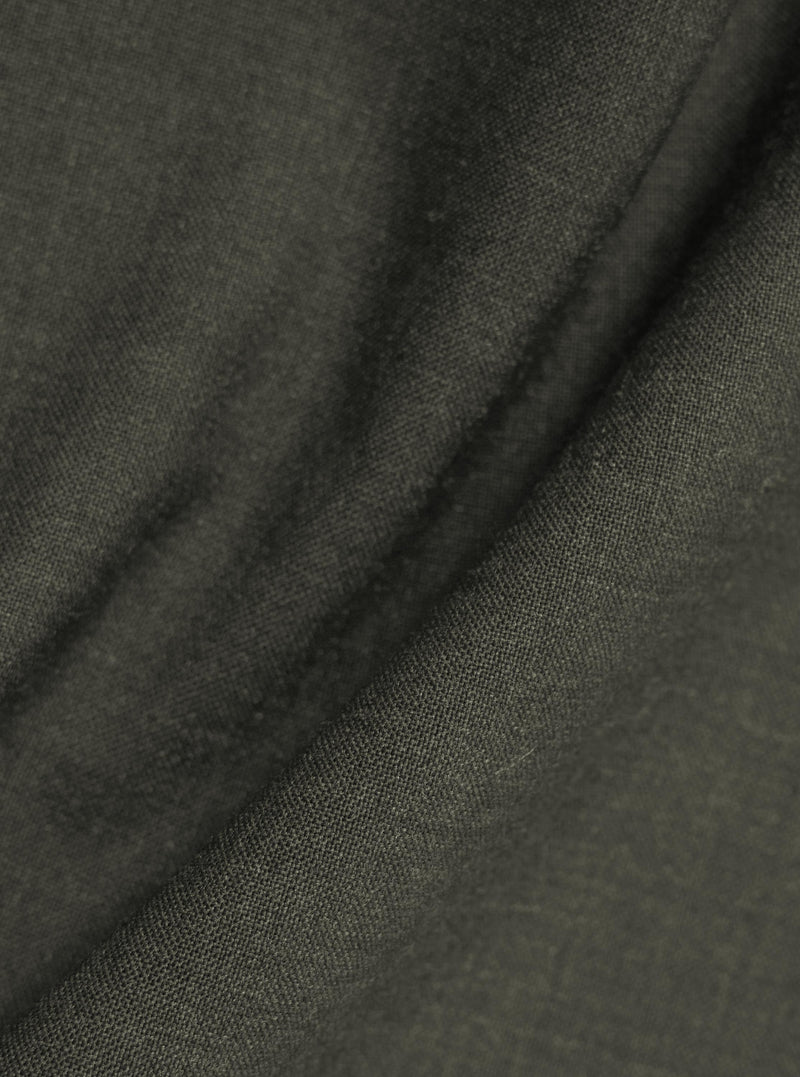 A detailed close-up fabric swatch of the Olive Marl Tropical Suiting Ewan Shirt. The image highlights the textured olive green marl weave and the fine detail of the polyester and wool blend material.