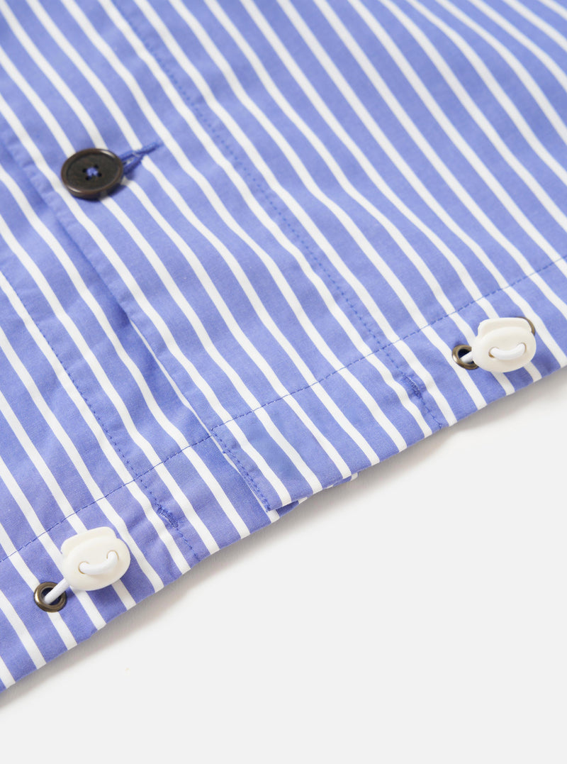 The Blue/White Cotton Stripe Z Tech Overshirt is displayed from the back, laid flat against a plain white background. The image highlights the horizontal back yoke and a central box pleat, showcasing the fine blue and white vertical stripe pattern of the cotton fabric. The elasticated hem is prominent at the bottom of the garment.