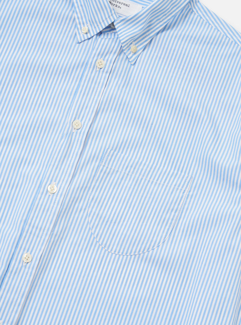 A detail shot of the Sky/White Classic Nipon Stripe Lazy Day Shirt is displayed against a plain white background. The image focuses on the upper portion of the shirt, highlighting the vertical blue and white stripes, the button-down collar, and the top buttons of the placket.