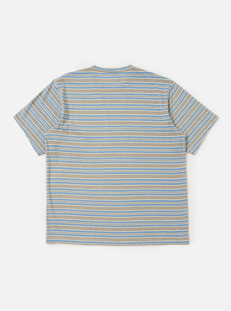 The Pale Blue OS Stripe Jersey Core Tee is shown from the back, laid flat against a plain white background. The image highlights the horizontal light blue and white stripes, the short sleeves, and the clean, straight hem of the garment.