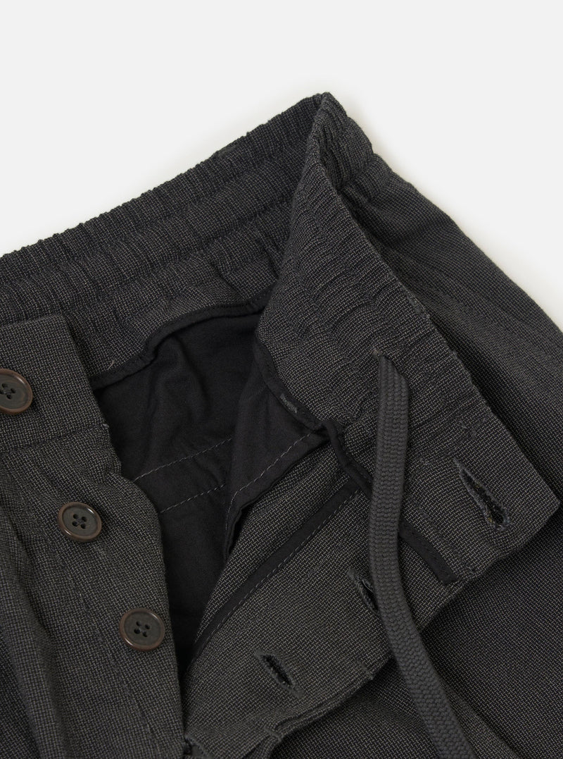 The Charcoal Seattle Cotton Pleated Track Pant is displayed flat against a plain white background. The charcoal grey trousers feature a relaxed fit with a tapered leg, a single pleat on each leg for added volume, and an elasticated waistband with a visible drawstring.