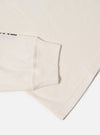 Close-up of the Paraboot x Universal Works Ecru Single Jersey Long Sleeve Tee. Shows the ecru color, jersey material, and long sleeve fit on a white background.