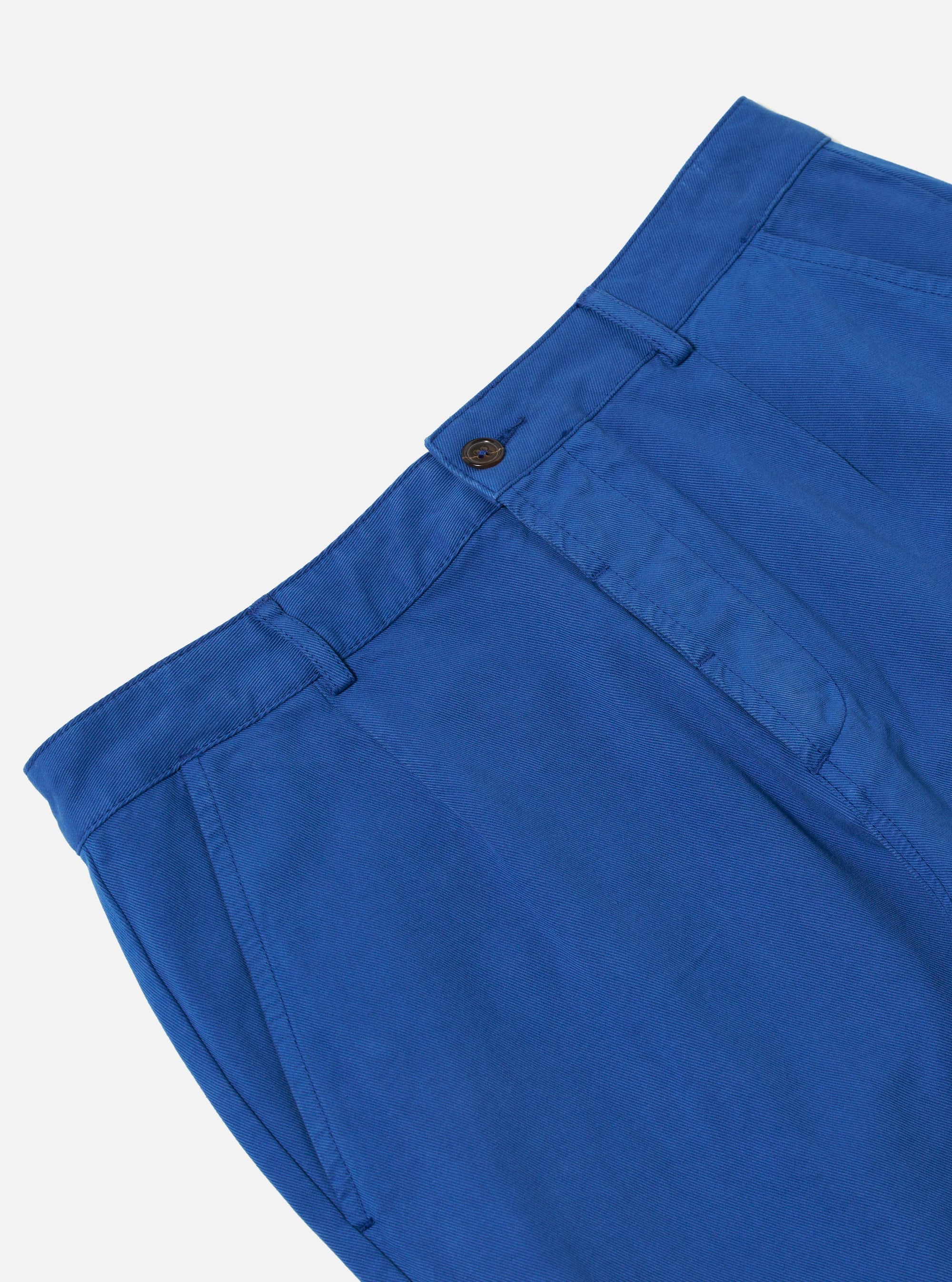 Close-up of the Navy Derek Twill Super Chino on a white background. The twill fabric shows a subtle texture. The fit looks modern and comfortable.