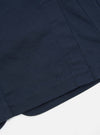 Close-up of the navy twill London jacket showing the fabric texture and stitching details. The jacket is laid on a white surface.