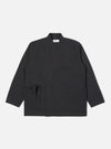 The Black Twill Kyoto Work Jacket, laid flat on a white background. The jacket is black twill with a wrap front and tie closure. It has two front pockets and a chest pocket.