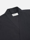 Close-up of the Black Twill Kyoto Work Jacket on a white background. The jacket is a dark gray twill with a V-neck and a label that says "Universal Works."