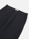 Close-up of Black Twill Military Chino pants on a white background. The twill fabric is visible, showcasing the fit and material. The staging is simple and clean.