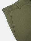 Close-up of Light Olive Twill Military Chino on a white background. The twill fabric shows texture and color. Details include the pocket and waistband.