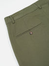 Close-up of the Light Olive Twill Military Chino on a white background, showing the twill fabric, back pocket with button, and belt loops.
