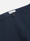 Close-up of the Navy Twill Military Chino on a white background. Shows the twill texture, button, and Universal Works label.