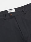 Close-up of the Black Twill Curved Pant on a white background. Details include the button, belt loops, and twill fabric texture.