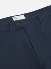 Close-up of the Navy Twill Curved Pant. The navy twill material is visible, along with the button and Universal Works label. Shot on a white background.