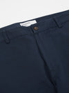 Close-up of the Navy Twill Aston Pant on a white background. The twill fabric is a deep navy color, and the pants have a classic fit.