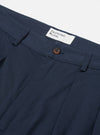 Close-up of the Navy Twill Double Pleat Pant on a white background, showing the double pleats, button, and twill fabric.