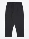 Studio shot on white of the Black Twill Pleated Track Pant. The pants are a dark color and made of twill, with a pleated front and relaxed fit.