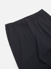 Close-up of the Black Twill Pleated Track Pant on a white background. The twill fabric has a subtle texture and the pleats add volume to the design.