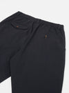 Close-up of the back of Black Twill Pleated Track Pant on a white background. The pants have an elastic waistband and buttoned pockets.