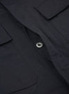 Close-up of the Black Twill MW Fatigue Jacket showing the twill texture, button, and pocket details. The jacket is laid flat on a neutral surface.