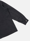 Close-up of the Black Twill MW Fatigue Jacket sleeve on a white background. The jacket is black twill with a buttoned cuff and a square pocket on the sleeve.