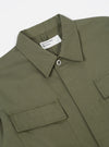 Close-up of the Light Olive Twill MW Fatigue Jacket on a white background. The twill texture and pocket details are visible.